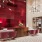 a room with a table and chairs and a large red wall